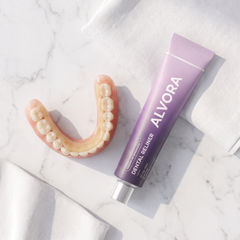 Lower denture with reliner layer beside Alvora tube